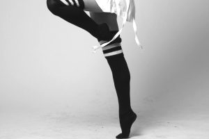 Black and white picutre of legs in high socks