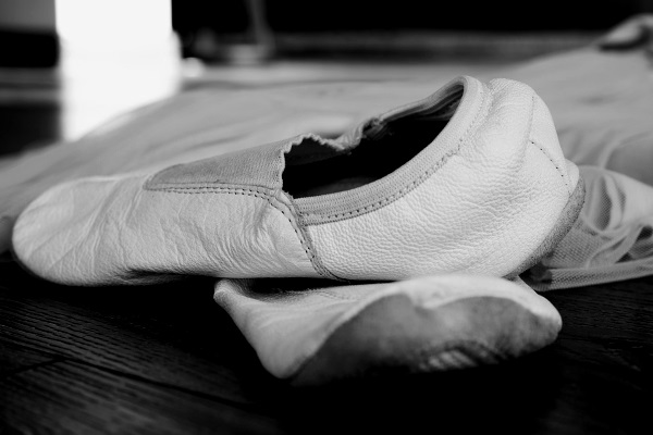 A black and white picture of some ballet shoes.